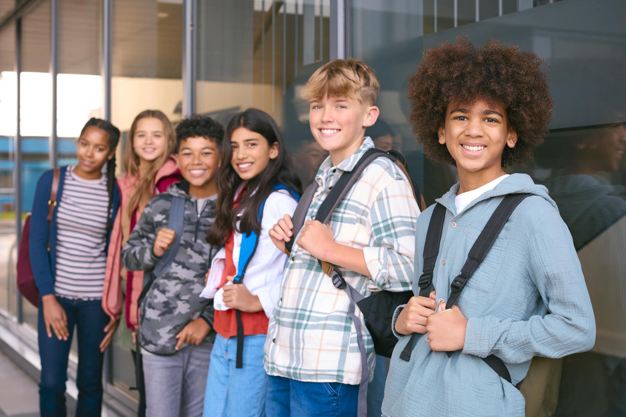Portrait Showing Class Of Secondary Or High School Pupils Standing Outside School Building